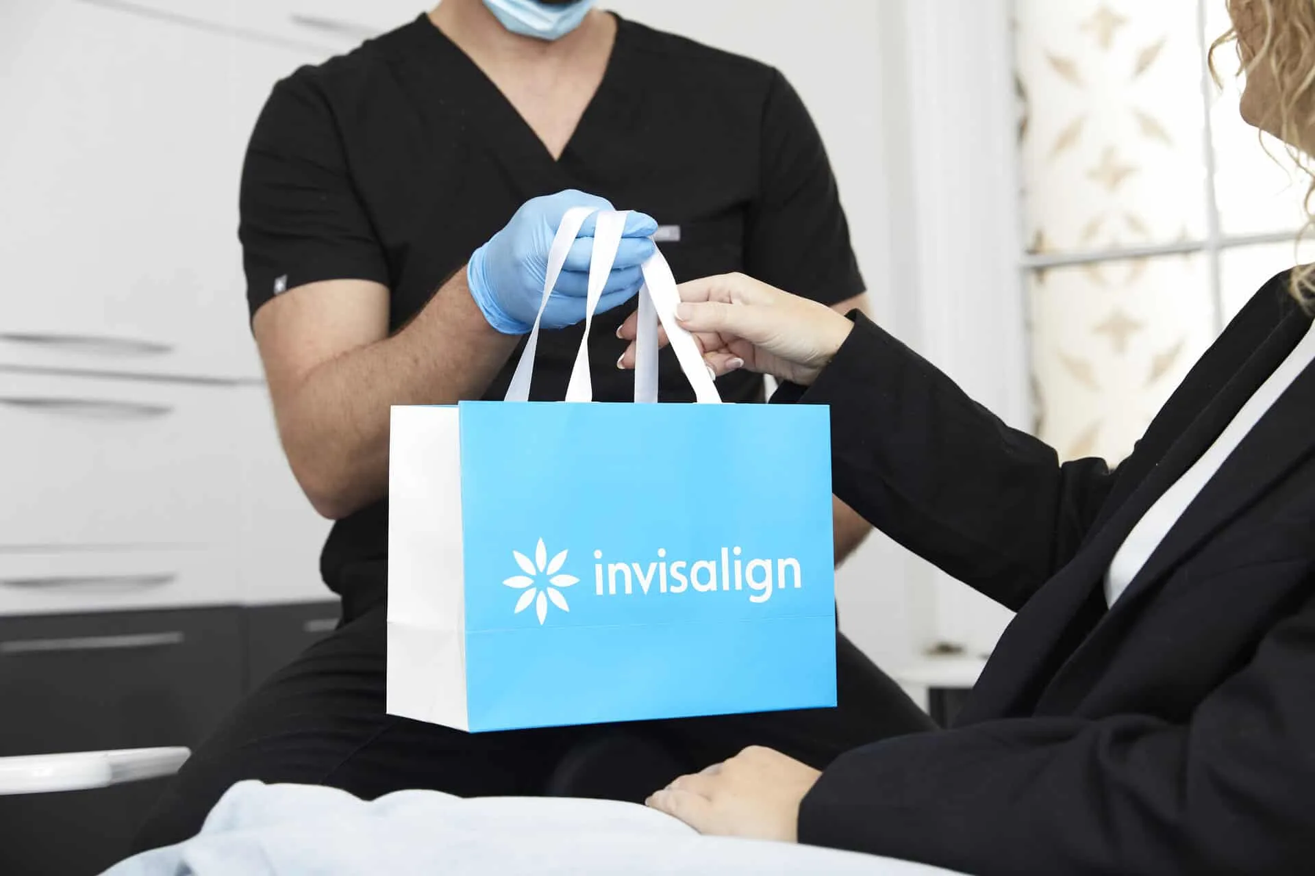 Invisalign bag being handed to patient