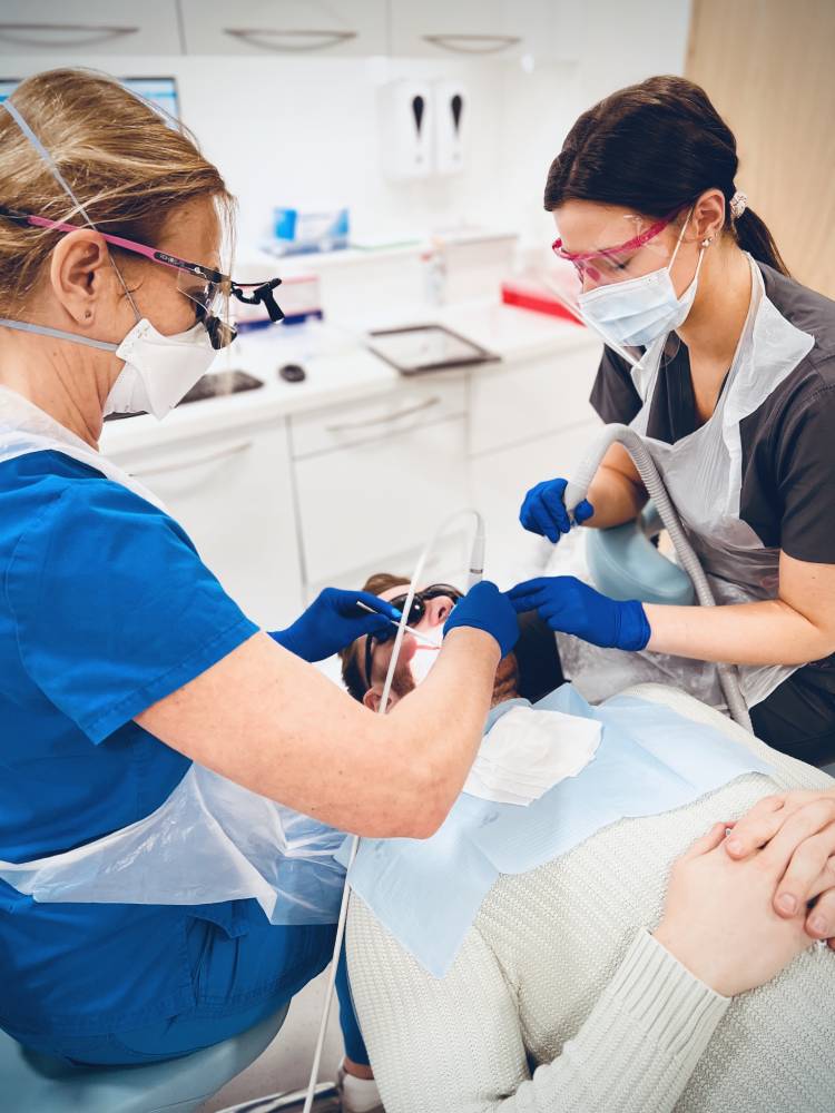 dental hygienist cleaning teeth