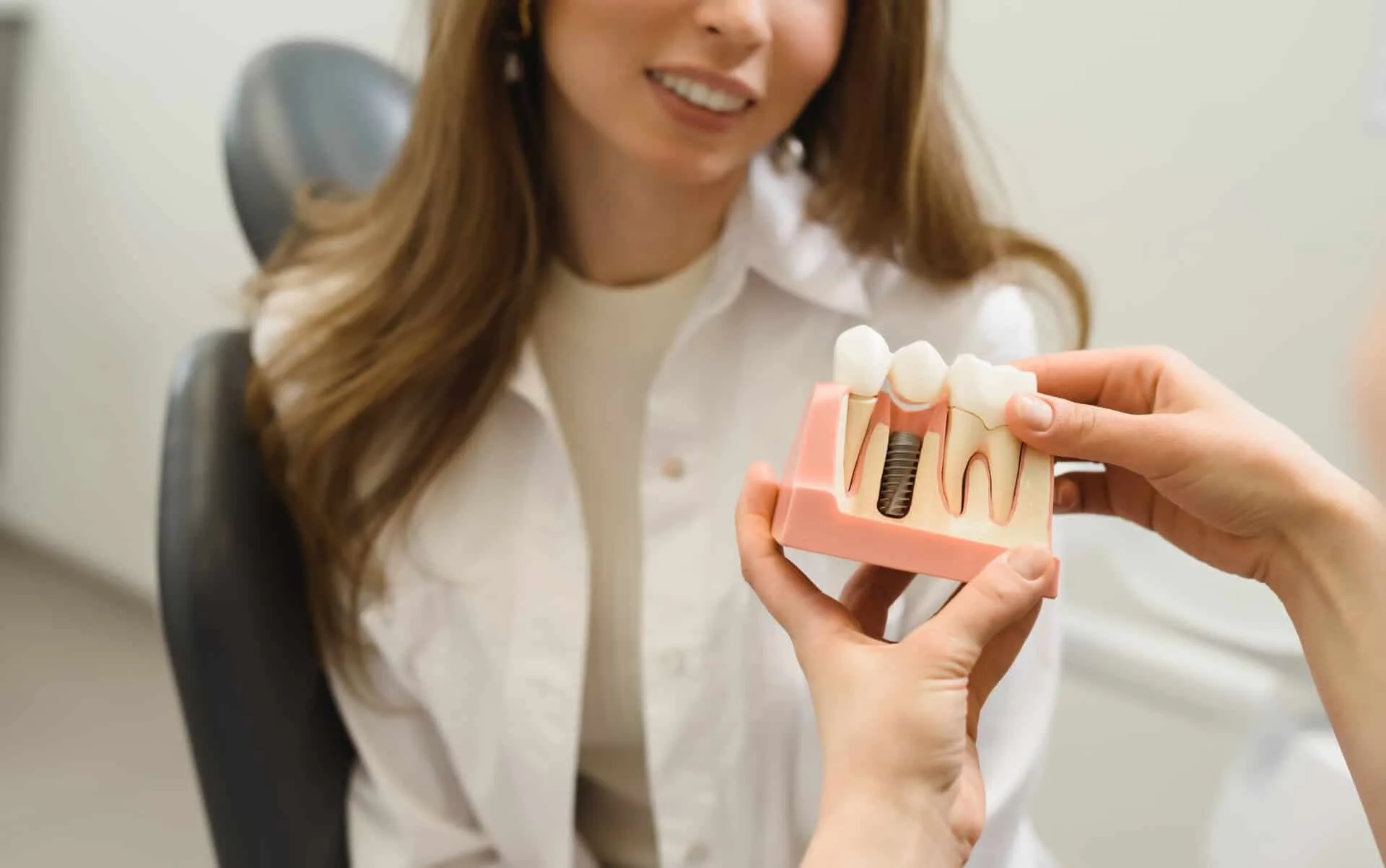 Dental Implants model and patient beyond dental
