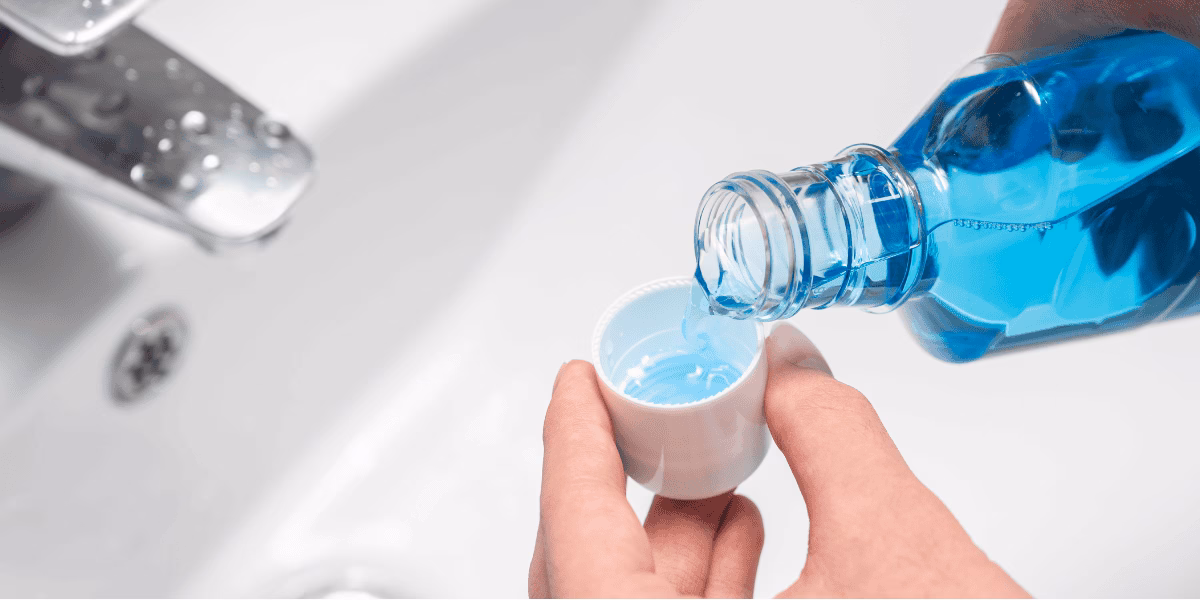 someone pouring mouthwash