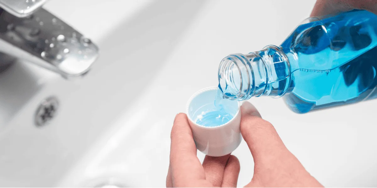 someone pouring mouthwash