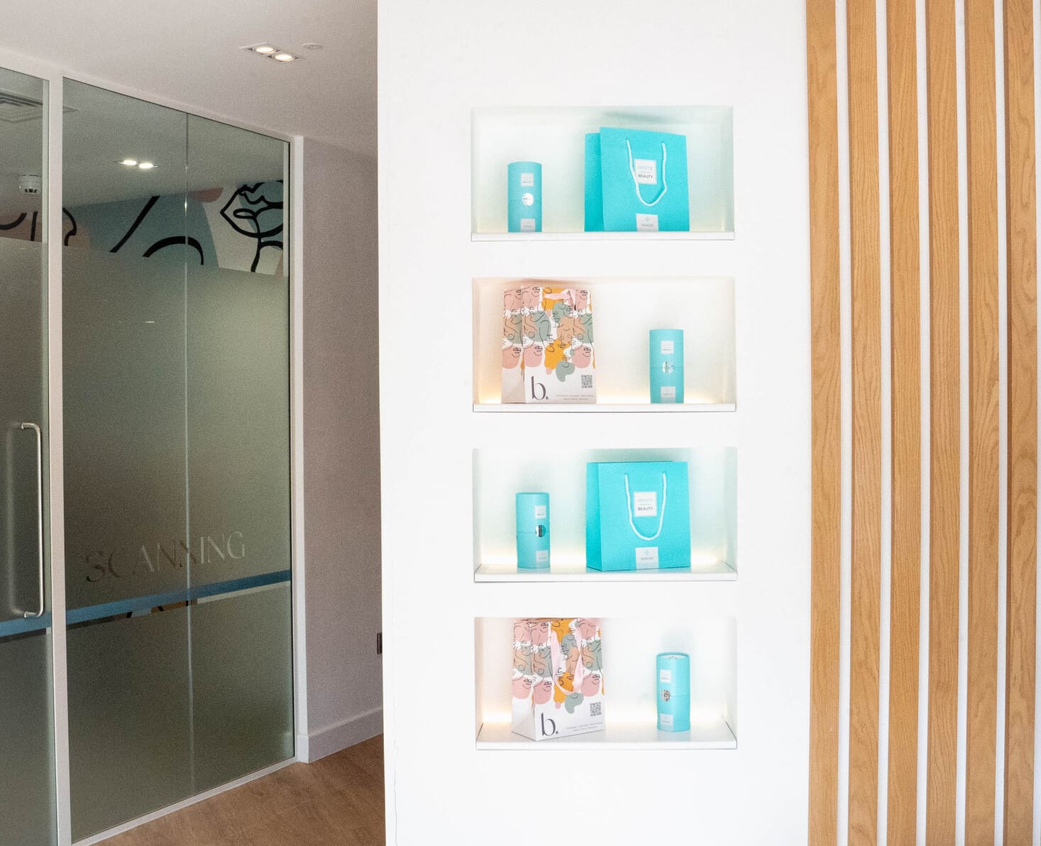 Dental clinic product display shelves with turquoise bags and branded boxes.