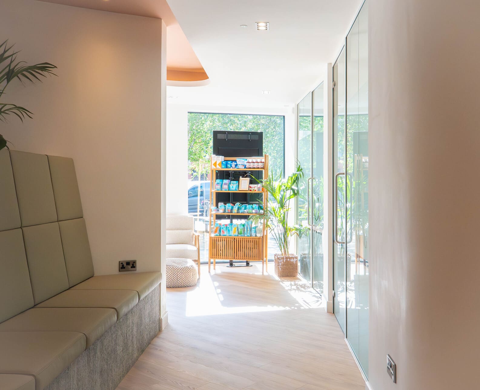 Bright dental clinic hallway with product display shelves and glass doors.