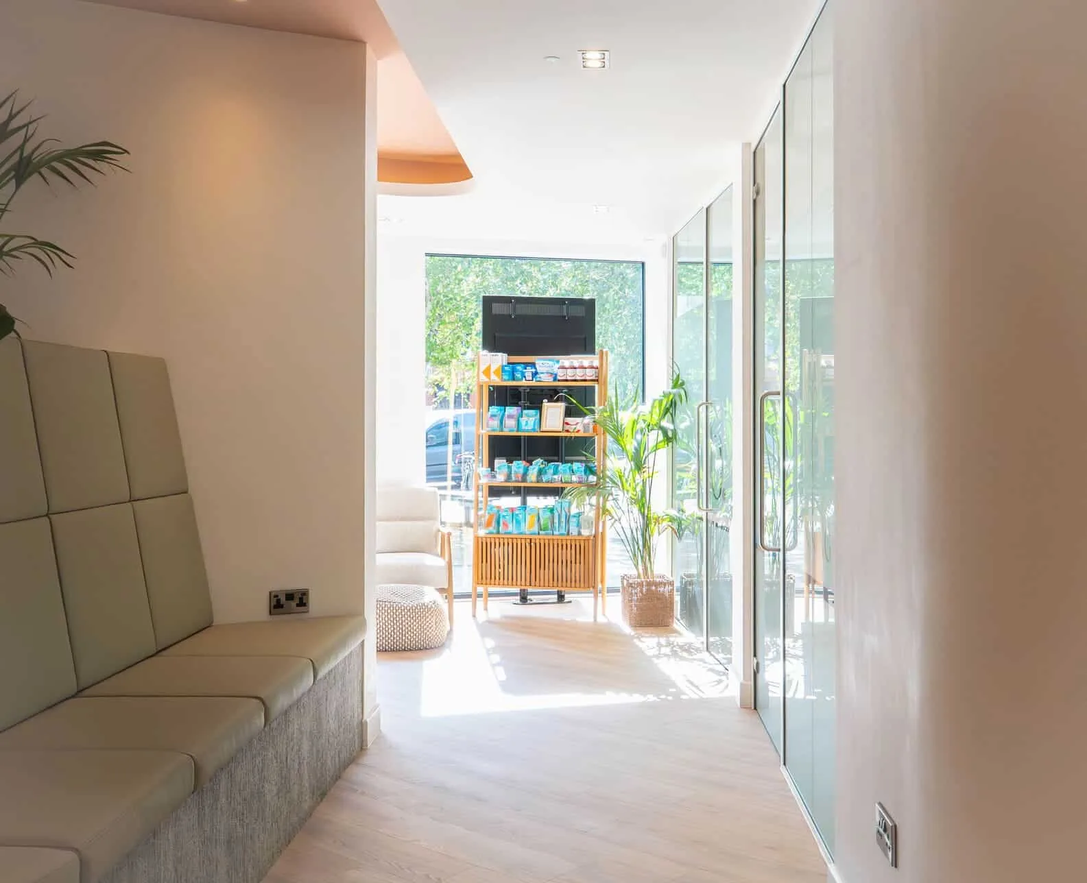 Bright dental clinic hallway with product display shelves and glass doors.